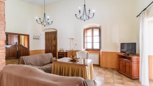 a living room with a couch and a tv at Villamada El Real de la Jara by Ruralidays in El Real de la Jara