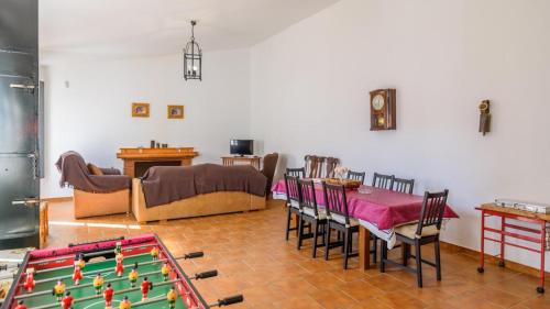 a living room with a pool table and a couch at Villamada El Real de la Jara by Ruralidays in El Real de la Jara