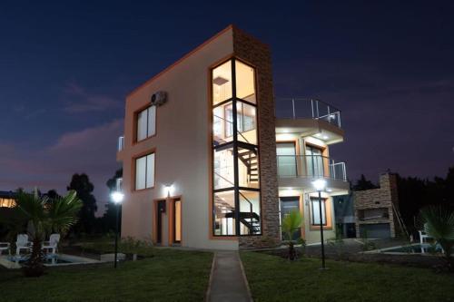 a large building with lights on at night at Terrazas del Ayuí in Concordia