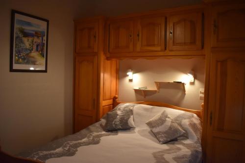 Un dormitorio con una cama con dos almohadas encima. en Au bon Accueil anciennement Le Jardin fleuri, en Bonnac