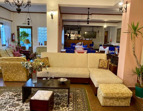 a living room with a couch and a table at Eleni's Guesthouse in Pisoderi