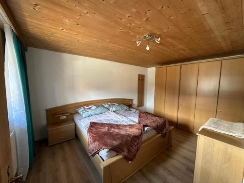 a bedroom with a bed and a wooden ceiling at Kuanerhof Wohnung 2 Personen in Ried im Zillertal