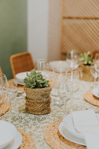 a table with plates and glasses and a plant on it at Natural Stay Apartamentos PassivHaus in Logroño