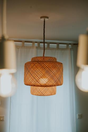 a light fixture hanging from a ceiling in a room at Natural Stay Apartamentos PassivHaus in Logroño