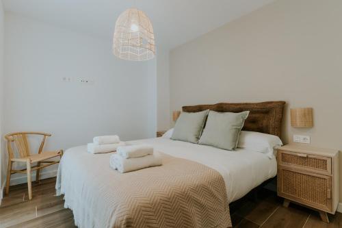 a bedroom with a bed with towels on it at Natural Stay Apartamentos PassivHaus in Logroño