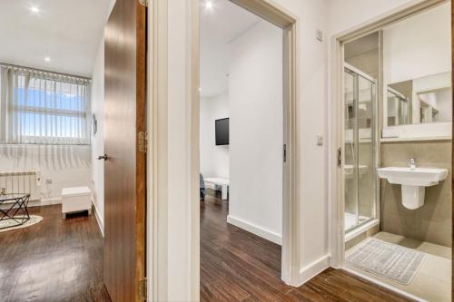 a bathroom with a sink and a mirror at Fantastic 1 Bed by Heathrow Airport in London