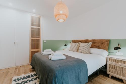 a bedroom with a bed with towels on it at Natural Stay Apartamentos PassivHaus in Logroño