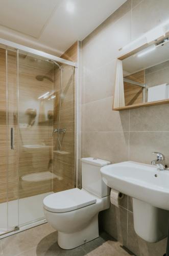 a bathroom with a toilet and a sink and a shower at Natural Stay Apartamentos PassivHaus in Logroño