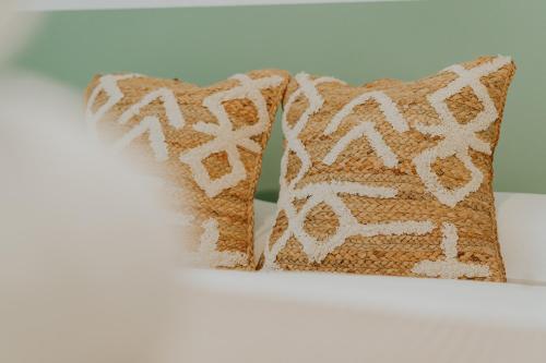 a pair of pillows sitting on top of a bed at Natural Stay Apartamentos PassivHaus in Logroño