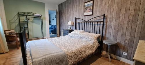 a bedroom with a large bed and a mirror at Chezshells GR34 - Telgruc Gite in Telgruc-sur-Mer