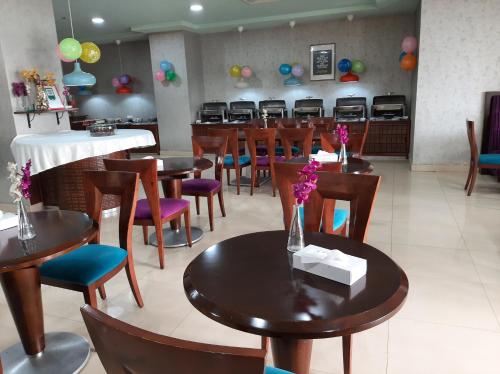 a dining room with tables and chairs and balloons at Al Manar Grand Hotel Apartment in Dubai