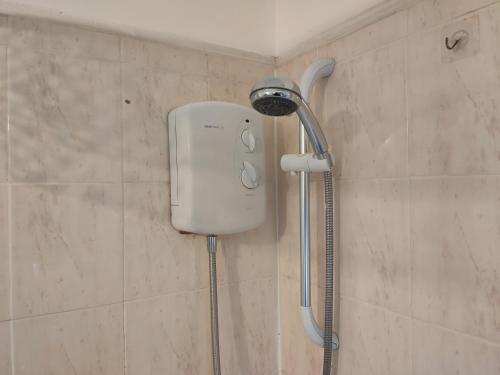 a shower head on a wall in a bathroom at Whitchurch 1 Bedroom Apartment in Cardiff