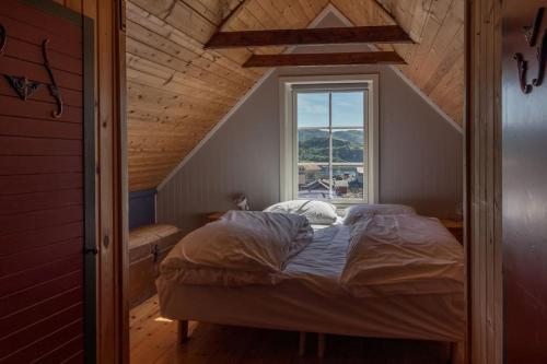 a bed in a room with a window at Sharming cabin in Sund in Sund