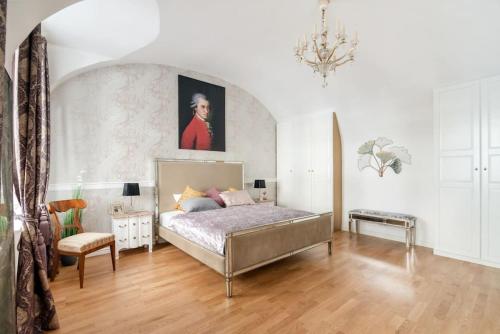 a bedroom with a bed and a painting on the wall at Papageno's Luxury Hideout in Vienna