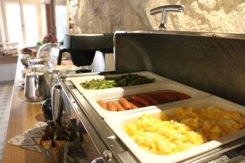 a tray of food on top of a stove at Hotel At the Green Grape in Prague