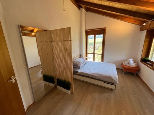 a bedroom with a bed and a sliding door at the Jad B&B in Comoret