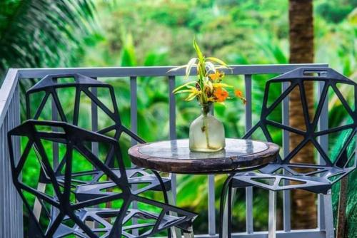 a vase with flowers on a table on a balcony at Camp Mayagay Tanay Rizal in Sampalok