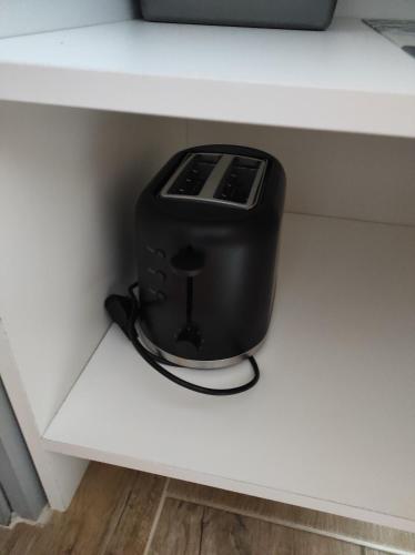 a black toaster sitting on top of a shelf at Haus Kraus in Bayerisch Eisenstein