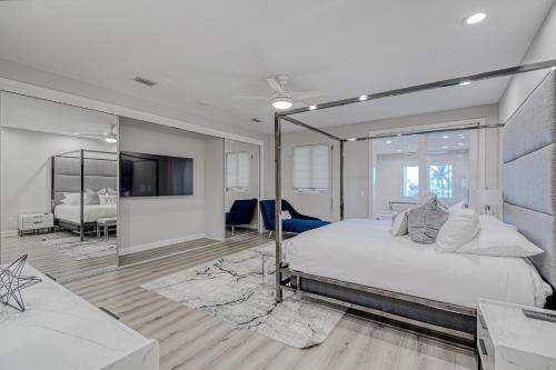 a bedroom with a large bed and a mirror at Highland Beach Palace in Highland Beach