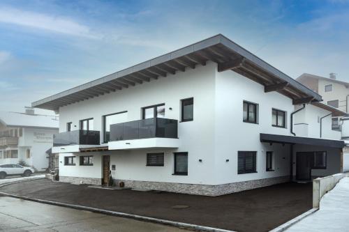 a white house with a lot of windows at Alps Holaus in Aschau