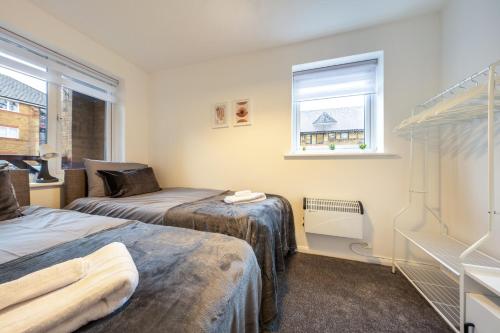 מיטה או מיטות בחדר ב-Luxury 2 Bed Apartment Stansted Airport Bishops Stortford