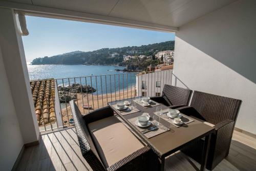 a balcony with a table with a view of the ocean at Penthouse Cortey in Calella de Palafrugell