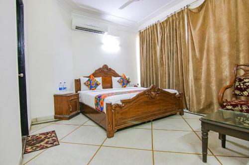 a bedroom with a wooden bed in a room at Via Singh Suite in Gurgaon