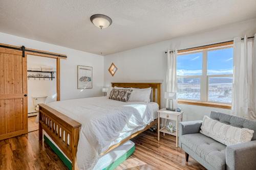 a bedroom with a bed and a couch and a window at Sunrise Vista Villa in Angel Fire