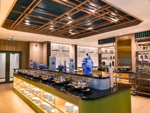 a kitchen with a counter with blue vases on it at The Quarter Chaophraya by UHG in Bangkok