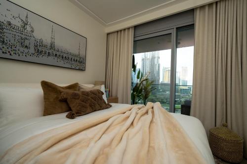 a bedroom with a bed with a large window at Majestay - Luxury Living in Dubai