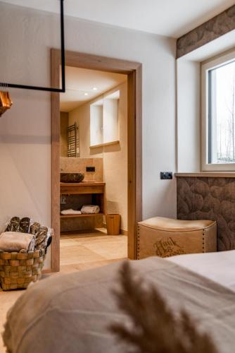 a bedroom with a bed and a chair in a room at CHILL HOUSE in Schladming