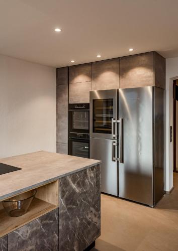 a kitchen with a stainless steel refrigerator and oven at CHILL HOUSE in Schladming