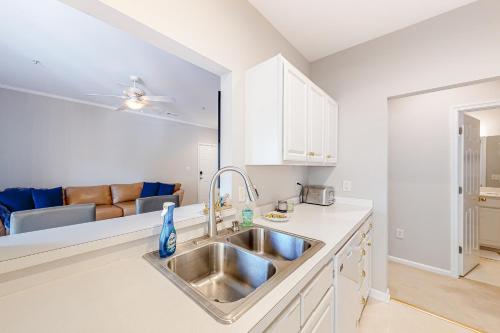 a kitchen with a sink and a living room at Creekwood --- 100 Cascade Ln, #109 in Rehoboth Beach