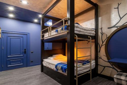 a bunk bed room with two bunk beds in it at Emily Magic Hostel in Vynnyky