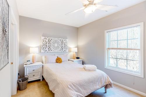 a white bedroom with a bed and a window at Creekwood --- 100 Cascade Ln, #109 in Rehoboth Beach