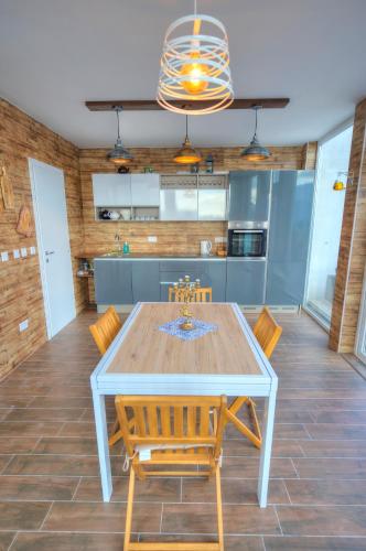 a dining room with a table and chairs in a kitchen at Spectacular spacious house with sun terrace ILJU1-1 in Sliema