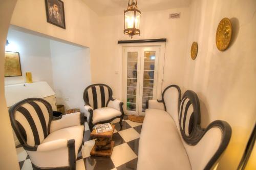a living room with four chairs and a table at Spectacular spacious house with sun terrace ILJU1-1 in Sliema