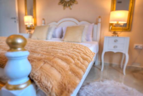 a bedroom with a bed and a table with a lamp at Spectacular spacious house with sun terrace ILJU1-1 in Sliema