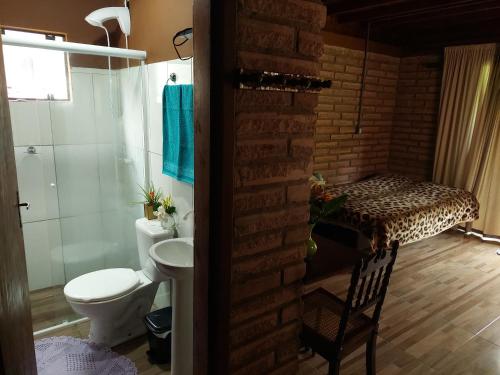 a bathroom with a toilet and a sink and a shower at Recanto da Paz - Aos pés do Morro da Borússia in Osório