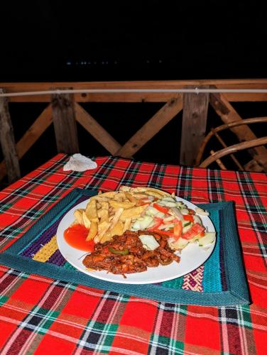 a plate of food sitting on a table at Mawe Mawili in Tanga