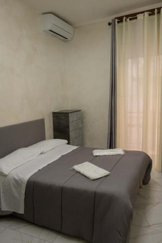 a bedroom with a bed with two towels on it at Casa vacanza russo enzo in Naples