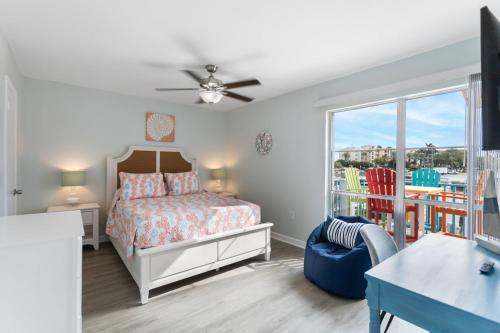 a bedroom with a bed and a balcony at 261 G Madeira Beach Yacht Club in St Pete Beach