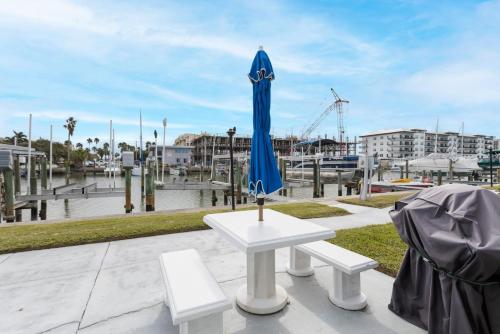 a blue umbrella sitting on top of a white table at 261 G Madeira Beach Yacht Club in St Pete Beach