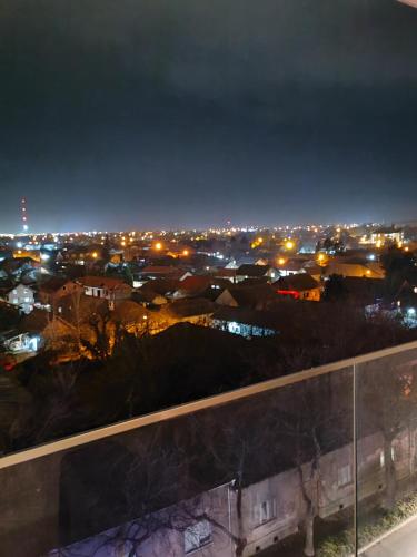 a view of a city at night with lights at Krstić_lux apartman in Subotica