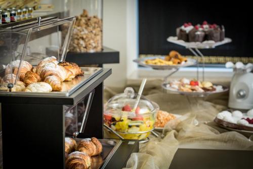 a buffet line with pastries and other food items at Best Western Premier Milano Palace Hotel in Modena