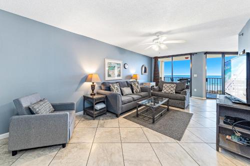 a living room with a couch and chairs and a tv at Phoenix V 202 in Orange Beach