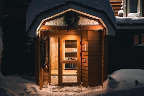 una pequeña casa de pan de jengibre con una puerta en la nieve en Country Inn Milky House en Niseko