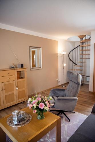a living room with a chair and a table at Geisbergerhof in Bad Birnbach