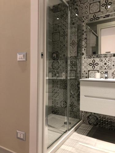 a glass shower in a bathroom with a sink at Trescene Room Locazione Breve Turistica in Benevento