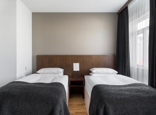 a bedroom with two beds and a window at Hotel Kea by Keahotels in Akureyri